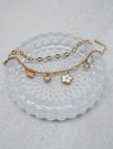 Armbånd med blomstercharms gullfarget stål thumbnail